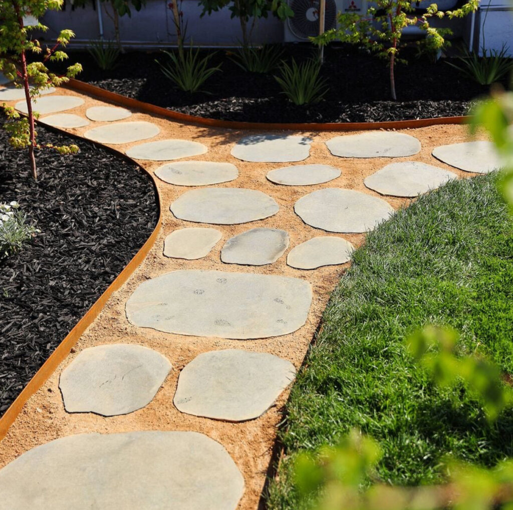 paver stone path with corten steel edging, bark and plants