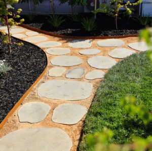 paver stone path with corten steel edging, bark and plants